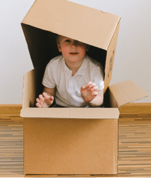 boy playing with moving boxes